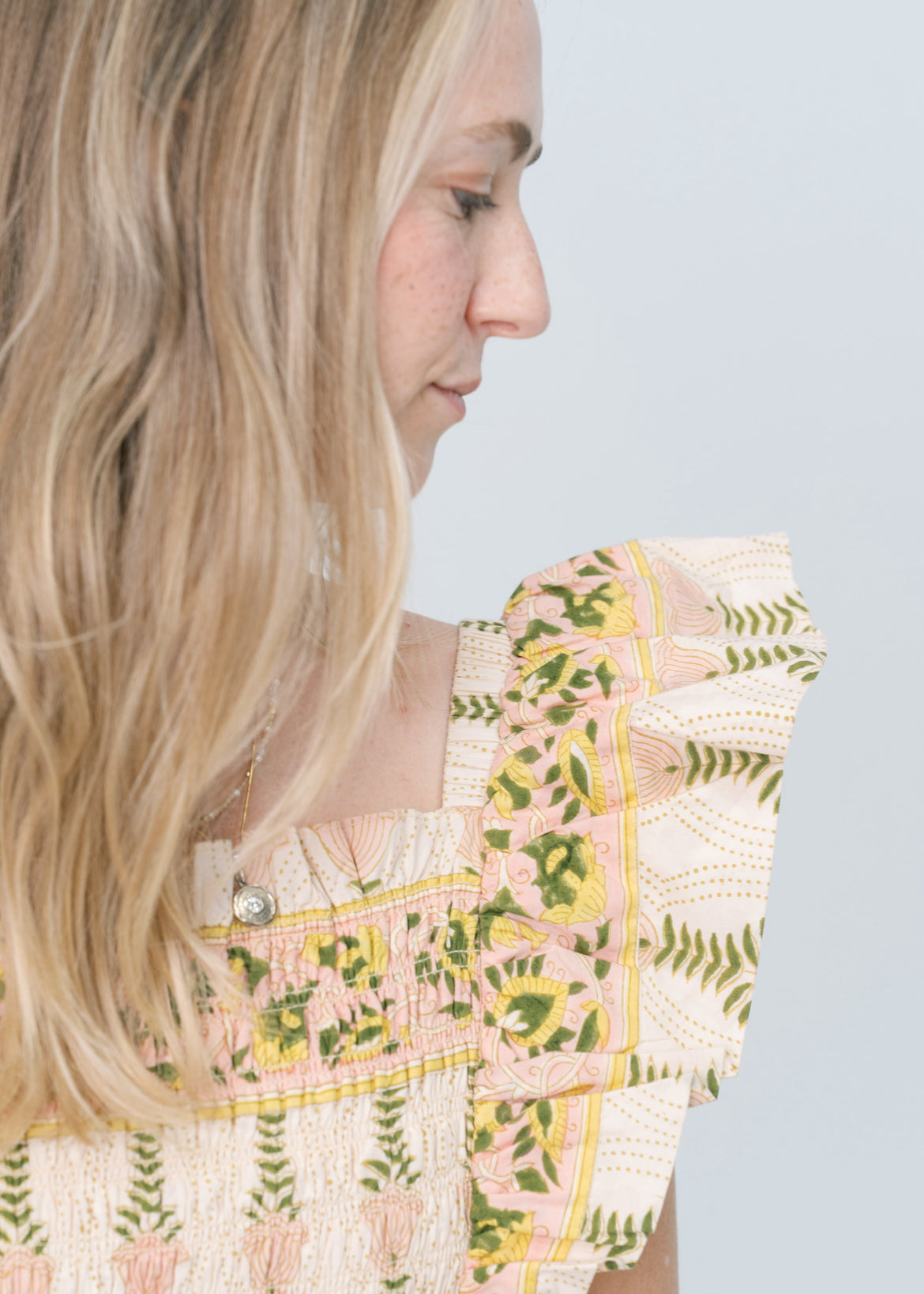Woman wearing a floral dress with a light blue background